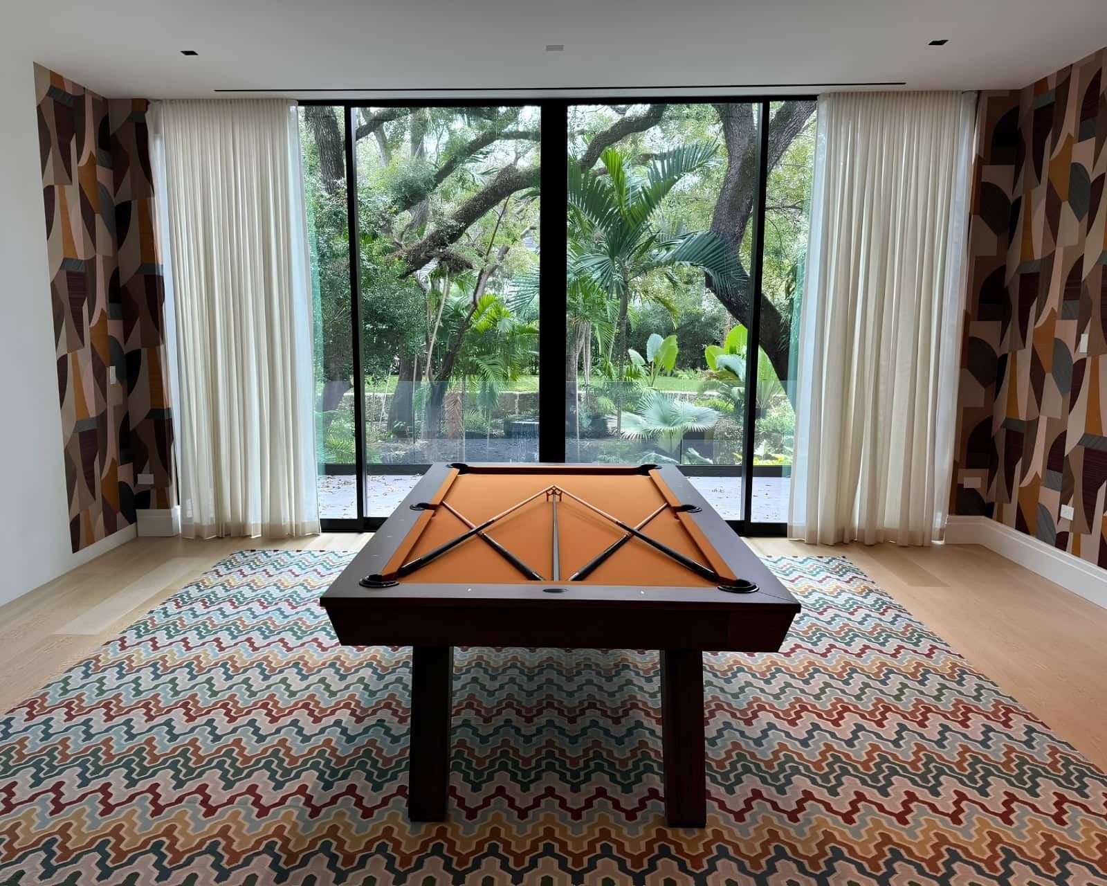 Custom Made in USA Doc & Holliday Muse pool table with orange felt in a richly layered Miami residence